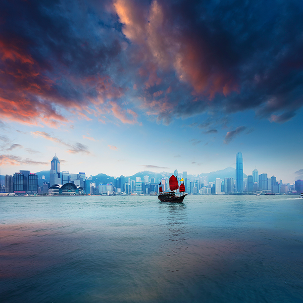 Traditional Chinese junkboat sailing across Victoria Harbour at sunset, Hong Kong (Photo by chinaface / Getty Images)
